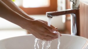 woman-washing-hands-with-hot-water